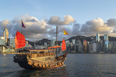 Junk boat and skyline of Hong Kong Island, Hong Kong, China, Asia stock photo