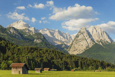 Hay barns at Hammersbach Footpath against Wetterstein Mountain Range, Garmisch-Partenkirchen, Werdenfelser Land, Upper Bavaria, Germany, Europe - RHPLF18373