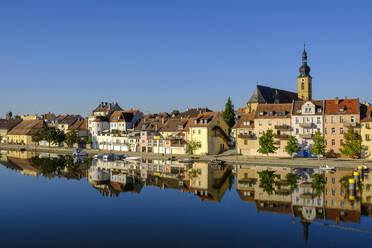 Germany, Bavaria, Kitzingen, Town buildings witch church seen across Main river - LBF03266