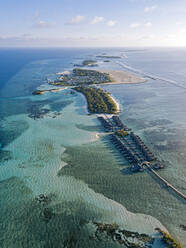 Maldives, Kaafu Atoll, Aerial view of bungalows of tourist resort on Huraa island - KNTF05885