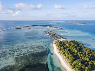 Maldives, Kaafu Atoll, Aerial view of green grove on Huraa island - KNTF05887