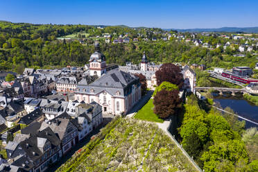 Germany, Weilburg, Weilburg Castle with baroque palace complex, old town hall and castle church with tower, aerial view - AMF08754