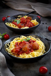 Two bowls of spaghetti with vegetarian polpette and basil - LVF09081