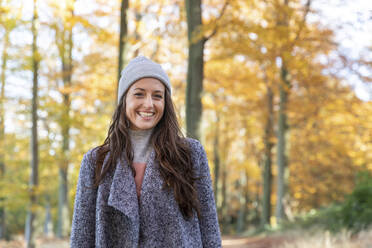 Beautiful female hiker standing in Cannock Chase forest during autumn - WPEF03692