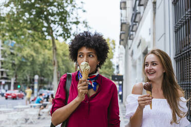 Friends having ice cream in the street - CAVF90603