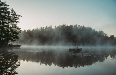 Mist rising off of a lake in the morning in Ontario, Canada. - CAVF90656