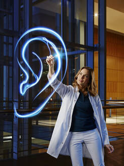 Female doctor analyzing ear in laboratory at hospital - RORF02447