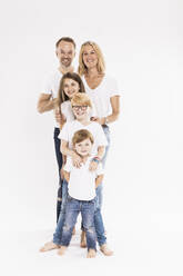 Happy family with children standing in row against white background - SDAHF00997