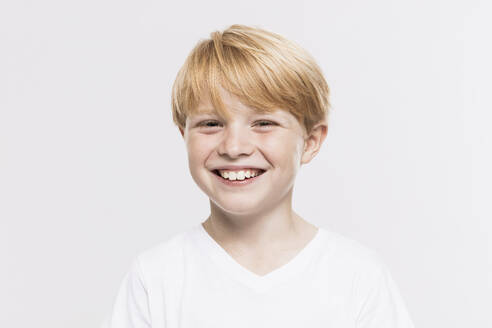Cheerful cute boy with blond hair against white background - SDAHF01006