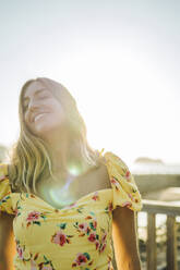 Beautiful young woman day dreaming in park during summer - MTBF00708