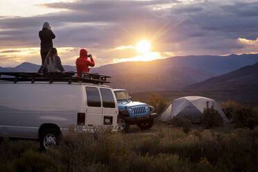 Friends looking at view while from van during sunset - CAVF90830