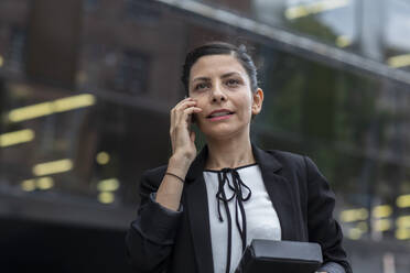 Woman leader standing outside in front of a building - CAVF91016