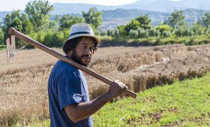 Colombian portrait with an orchard tool, copy space. - CAVF91048