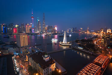 Skyline of the Pudong Financial district across Huangpu River at dusk, Shanghai, China. - MINF15401