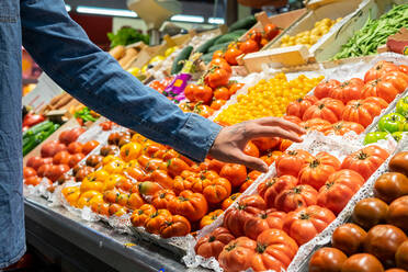 Abgeschnittener, nicht erkennbarer männlicher Kunde, der beim Kauf von Lebensmitteln im Supermarkt frische Lebensmittel auswählt - ADSF17924