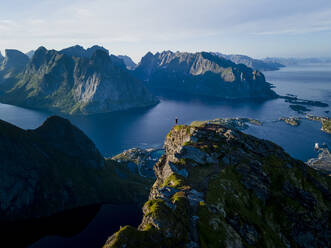 Woman standing on mountain peak at Reine, Lofoten, Norway - MALF00168