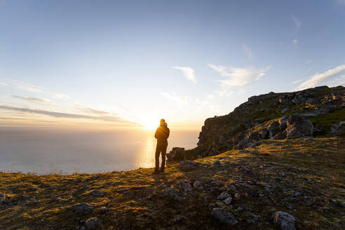 Man admiring view while standing on mountain at Ryten, Lofoten, Norway - MALF00220