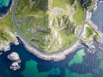 Road by mountain on island at Andoya, Norway - MALF00273