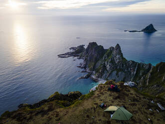 Explorers camping on mountain at Matind, Andoya, Norway - MALF00280