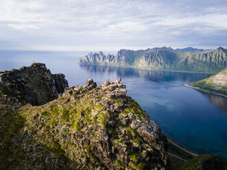 Woman standing on mountain at Husfjellet, Senja, Norway - MALF00296