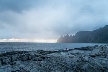 Hiker looking at view while standing at Tungeneset, Senja, Norway - MALF00302