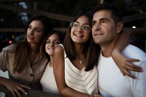 Happy family looking away while spending leisure time during vacation - RCPF00374