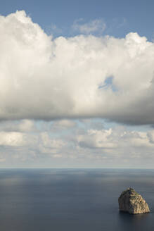 Weiße Wolken über einem aus dem Mittelmeer ragenden Felsen - JMF00535