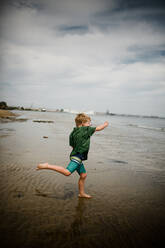 Six Year Old Boy Skipping Rocks in Coronado Bay - CAVF91162