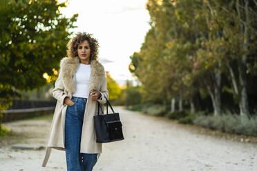 Elegant woman walking in the park - CAVF91171