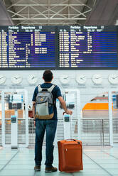 Young man waiting his flight at the airport - CAVF91205