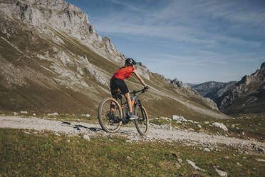 Radfahrerin auf einem Mountainbike im Nationalpark Picos de Europa, Kantabrien, Spanien - DMGF00382