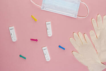 Studio shot of COVID-19 rapid diagnostic tests, pair of surgical gloves and protective face mask - MAUF03644