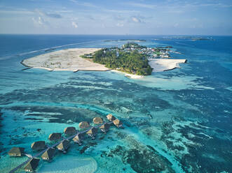 Maldives, Kaafu Atoll, Aerial view of tropical tourist resort on Huraa island - KNTF05997