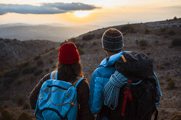  Male and female hikers enjoying sunset from mountain during vacation - RCPF00415