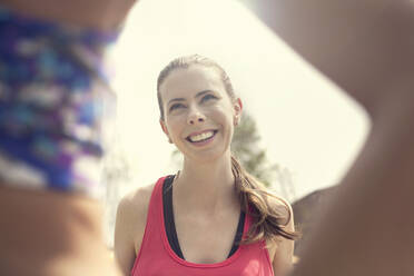 Smiling woman talking to friend on sunny day - AJOF00698