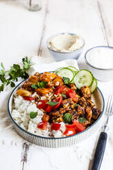 Bowl of Greek gyro with rice, fava beans, halloumi cheese, tomatoes and cucumbers - SBDF04437