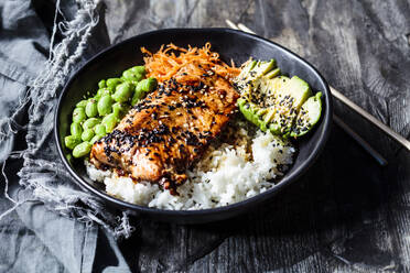 Schüssel mit Teriyaki-Lachs mit Reis, Karottensalat, Edamame-Bohnen, Avocado und Sesam - SBDF04445