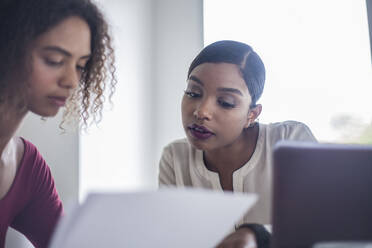 Businesswomen brainstorming during meeting in office - AJOF00781