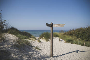 Wooden directional sign against clear sky at Mecklenburg, Fischland-Darß-Zingst, Germany - CHPF00720