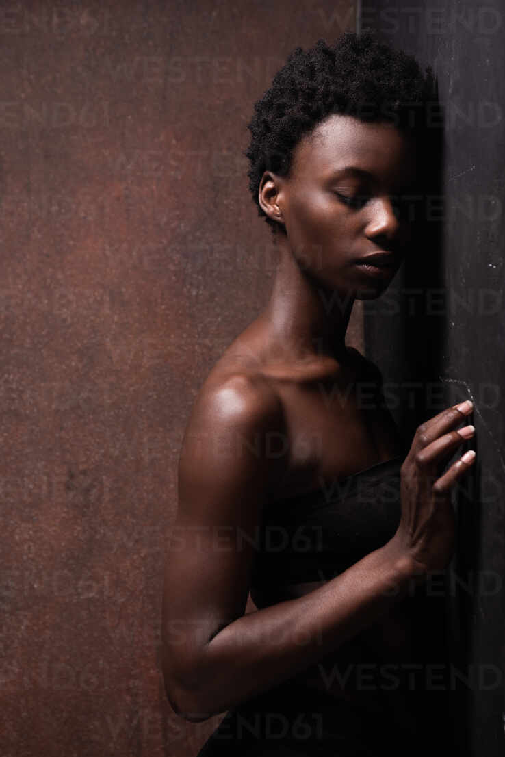 Seductive African American female model wearing black top with