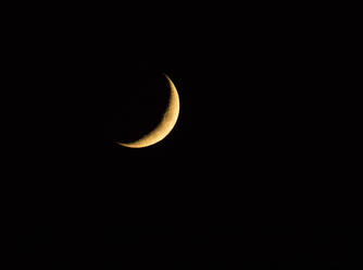 Waxing Crescent moon glowing against pitch black sky at night - ZCF01023