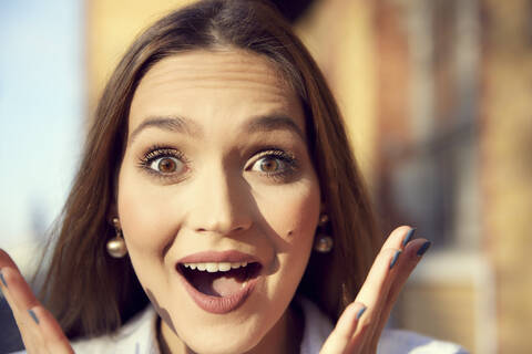Close-up of businesswoman with surprised facial expression standing outdoors stock photo