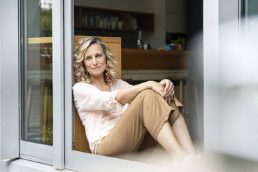 Smiling female professional looking away at doorway of office cafeteria - PESF02448