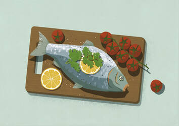 Whole cooked fish with lemons and tomatoes on cutting board - FSIF05447