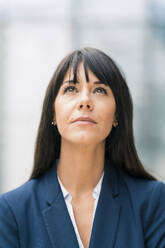 Thoughtful businesswoman with bangs looking up - JOSEF02546