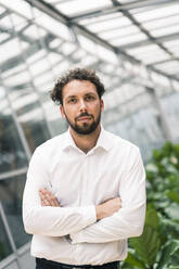 Male entrepreneur with arms crossed in office - JOSEF02634