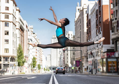 Ballet dancer dancing on road in city stock photo