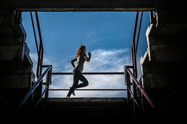 Fit Woman Doing Workout at a Stadium - CAVF91371