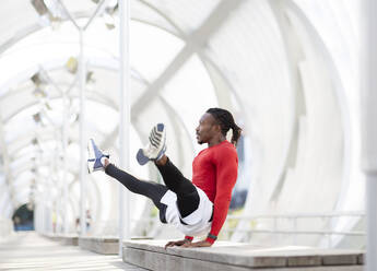 Sportsman balancing while doing handstand on walkway - JCCMF00182