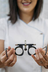 Smiling female optometrist with eyeglasses in clinic - MPPF01304